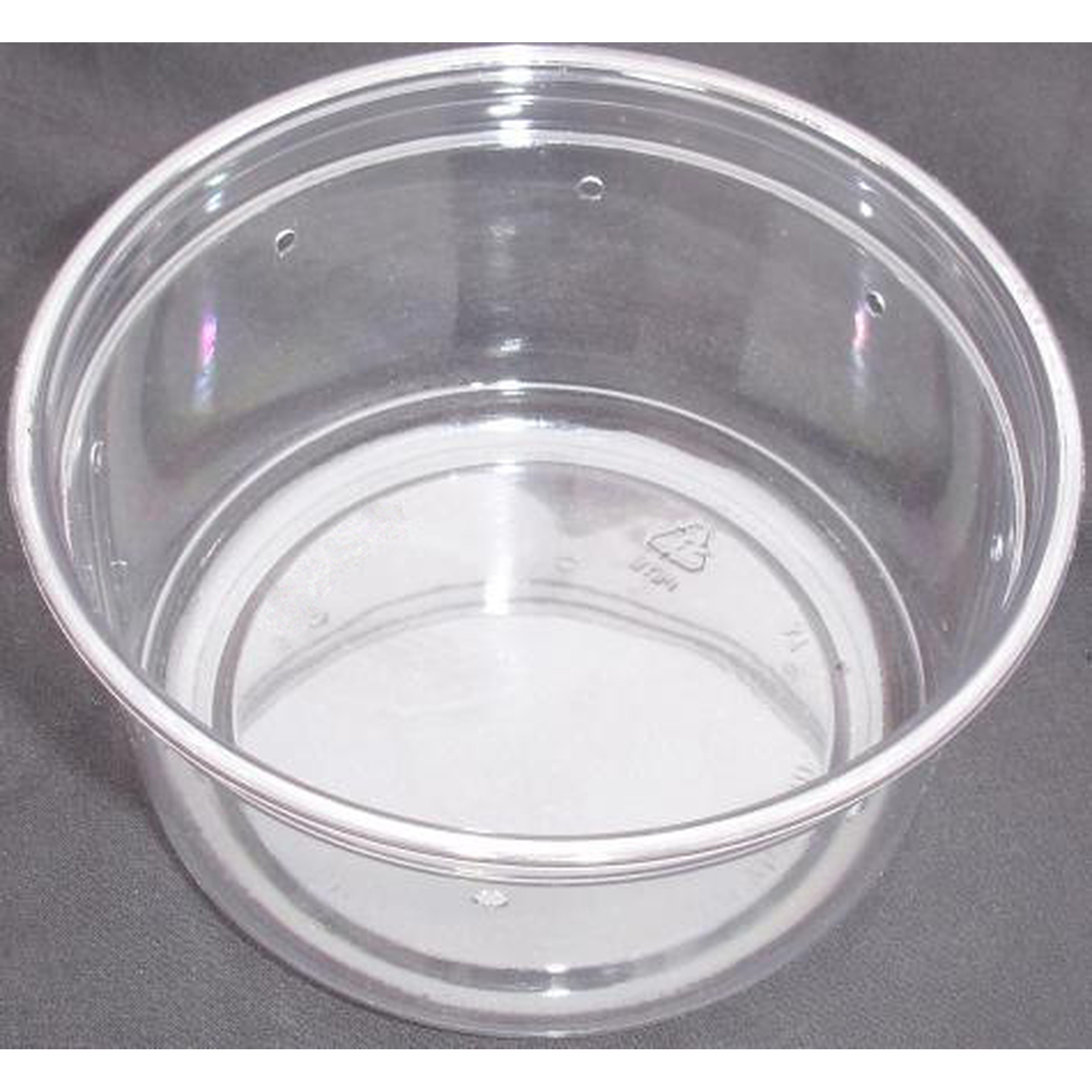 Clear plastic cup on a dark surface, empty, showing its round rim and inner base.