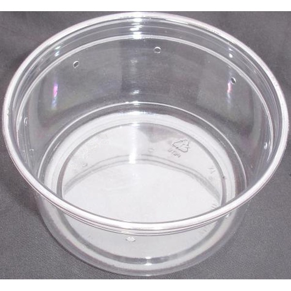 Clear plastic cup on a dark surface, empty, showing its round rim and inner base.