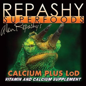 Close-up of a green chameleon on a Repashy Superfoods Calcium Plus LOD packaging for vitamin and calcium supplement.