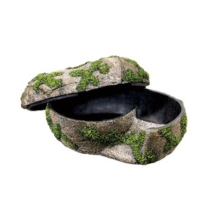 Moss-covered stone shell-shaped box with a hinged, ajar lid revealing a dark interior.