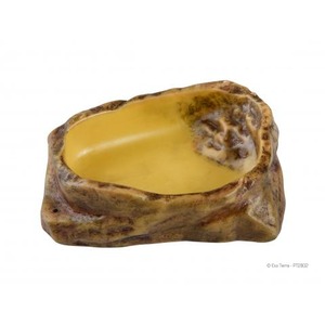 Rugged rock bowl filled with smooth yellow creamy substance inside.