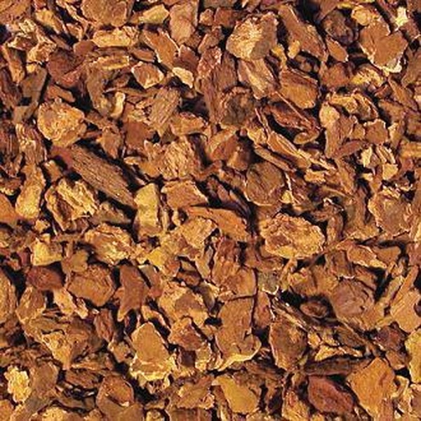 Close-up of brown wood mulch bark chips scattered densely.