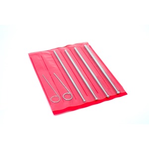 Set of stainless steel dental tools laid on a red sleeve, including long probes and two loop-ended picks.