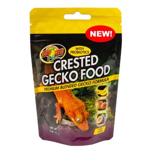Yellow-and-black pouch of Crested Gecko Food with gecko image, "NEW!" label and probiotics.