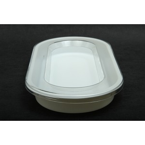Shiny white plastic lid with a recessed central area on a dark surface