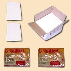 Two folded white cloths, an open cardboard box, and two UniHeat heat packs.