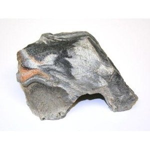 Weathered gray rock with dark and light layered bands and a curved hollow.