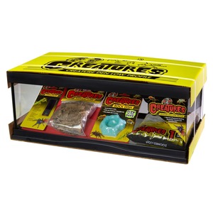 Yellow Creatures Creature Den low-profile terrarium kit opened with packaging, rock dish, and blue accessory.