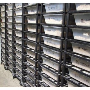 Rows of black wheeled carts with white bins stacked in a warehouse.