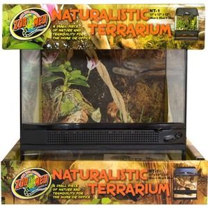 Naturalistic terrarium in a glass enclosure with plants and wood, displayed in colorful packaging.