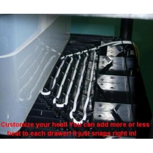 Row of metal wrenches arranged in a drawer-like rack inside a metal cabinet, with red caption text along the bottom.
