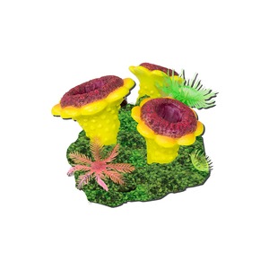 Bright yellow coral-like decorations with red centers on a green mossy base, with plastic sea plants.
