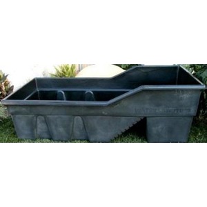 Grey plastic stock tank on a lawn, a large rectangular tub with an opening on one side.