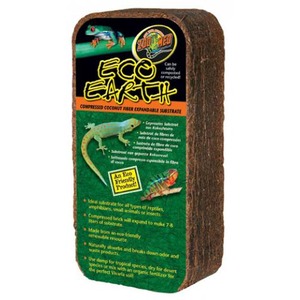 Brown compressed coconut-fiber reptile substrate brick labeled "Eco Earth" with colorful gecko illustrations on a green label.