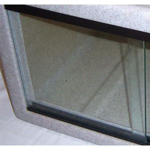 Close-up of a glass window pane set in a gray speckled frame