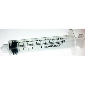 Clear syringe with black plunger and measurement scale, labeled monoject, lying horizontally.