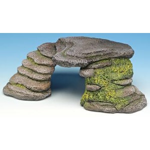 Stone arch formed by balanced stacked rocks, with moss on the right pillar.