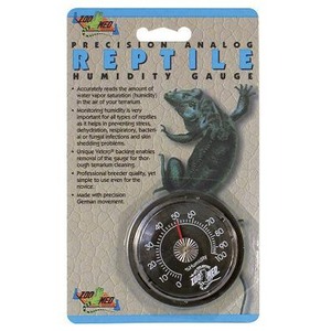 Analog reptile humidity gauge with a round dial thermometer on packaging featuring a blue iguana.