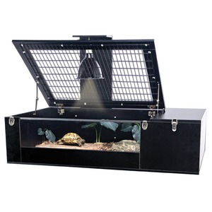 Black terrarium with a raised mesh lid, housing a basking turtle, plants, and soil substrate.