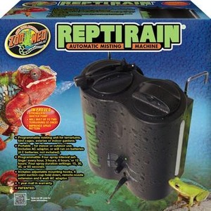 Reptirain automatic misting machine on packaging, black dual-tank unit with tubing, lizard graphic.
