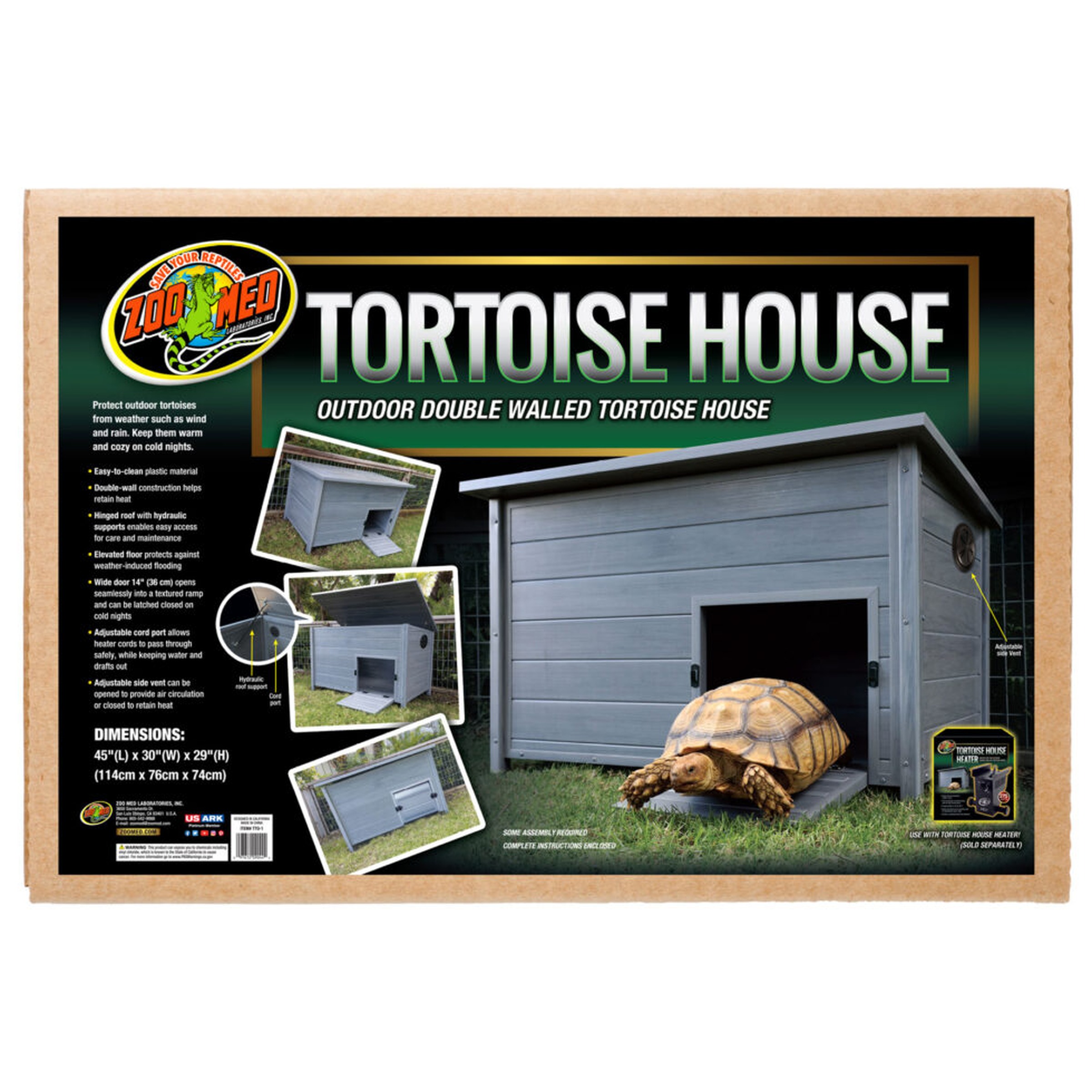 Outdoor double-walled tortoise house on green grass with a tortoise emerging from the door.