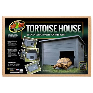 Outdoor double-walled tortoise house on green grass with a tortoise emerging from the door.
