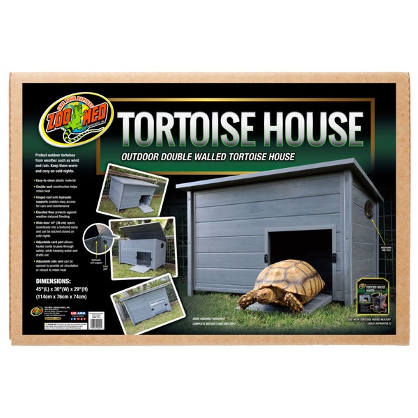 Outdoor double-walled tortoise house on green grass with a tortoise emerging from the door.