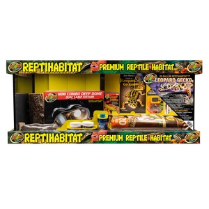 Colorful reptile habitat display with leopard gecko kit, lamp fixture and assorted supplies.