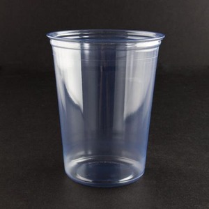 Clear blue plastic cup on a dark surface with soft reflections.