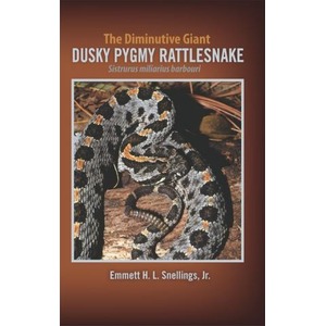 Coiled dusky pygmy rattlesnake on wooden ground; brown cover with orange text and author name.