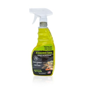 Yellow cleaning spray bottle with white nozzle, labeled Komodo-San reptile cage cleaner for terrariums.