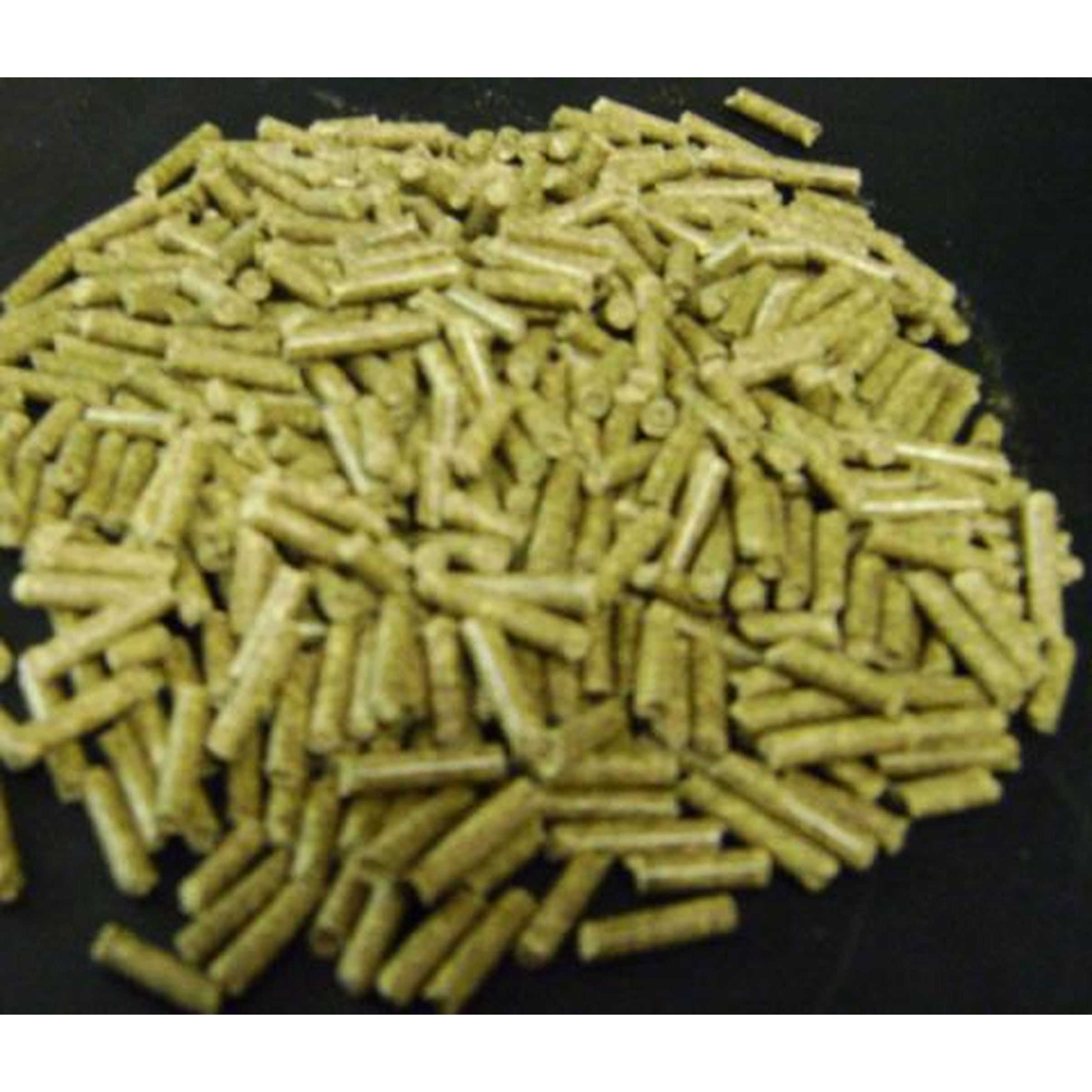 Pile of small greenish-yellow cylindrical pellets on a dark surface.