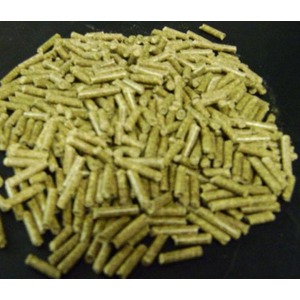 Pile of small greenish-yellow cylindrical pellets on a dark surface.