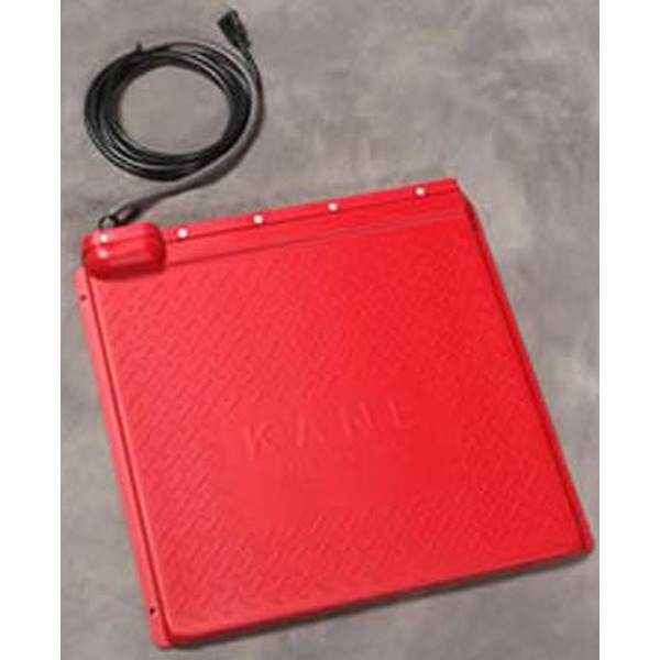 Red square electronic device with a textured surface and a coiled black cable beside it.