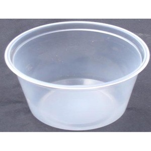 Clear plastic bowl on a dark surface, empty, with a wide rounded rim.