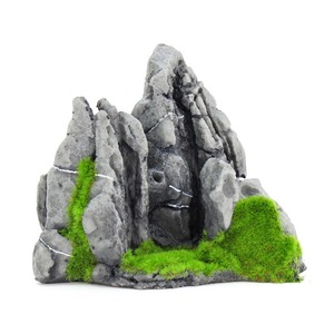 Tall jagged gray rock cluster with moss at the base and a dark crevice.