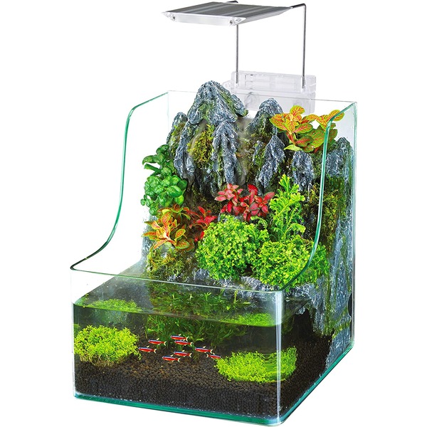 Glass paludarium with a rocky mountain backdrop, lush greenery, and a bottom aquarium with small red-and-white fish.