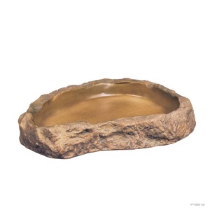 Rough brown stone trough with a smooth, shallow interior.