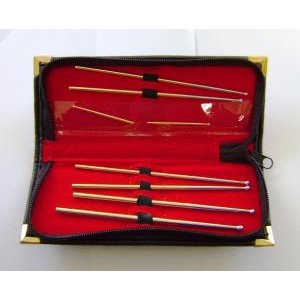 Open red-lined case with several long metal tools, each with a black grip, arranged in two rows.