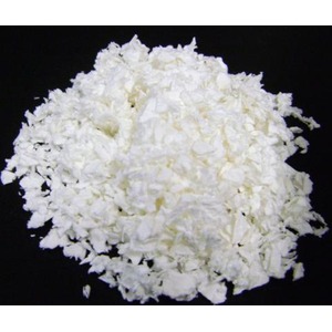 Pile of finely shredded white cheese on a black surface